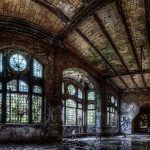 Panorama of a bed in a water pond inside the ruins of a Beelitz hospital building